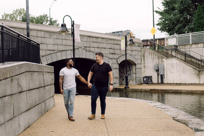 Engaged couple Micah and Dough walking along a path in Richmond, Virginia.