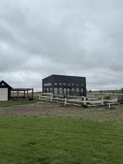 foggy morning view of the family farmhouse and fenced pasture in rural Kansas

