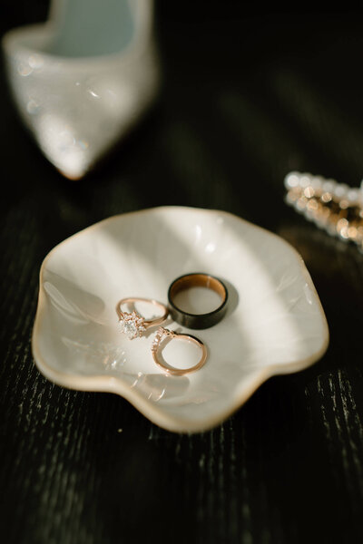Engagement Ring, and both Wedding Bands in a flat lay