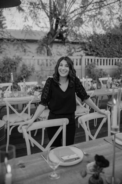 black and white photo of Sarah posed at backyard wedding reception