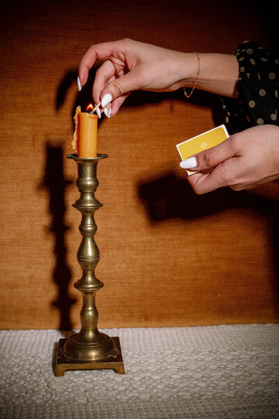 Woman striking a match and lighting a candle