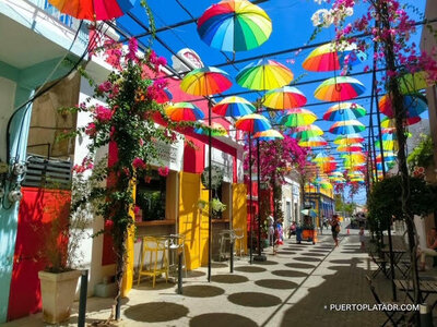 Vibrant street in Puerto Plata decorated with colorful hanging lanterns