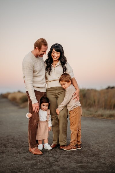 family of 4 hugging at the end of their photo shoot in martinez