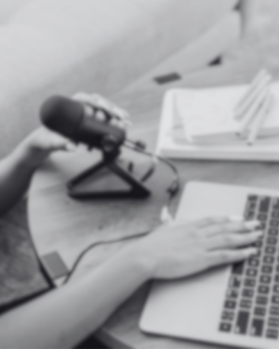 Stock image of a woman podcasting, representing confidence, self-love, and Main Character Energy aligned with Letitia Hopkins’ Encourage Over Everything podcast focused on life, love, and empowerment coaching.