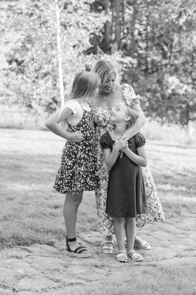 Mom and her daughters looking at each other | Family Photography