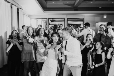 Bride and groom dancing with friends at their reception  - Alex Bo Photo