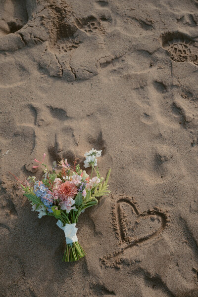 Flower bouquet laid on the sand