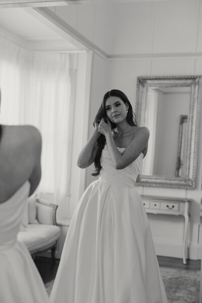 toowoomba Gabbinbar bride placing her earrings under her beautiful wavy hair, natural makeup