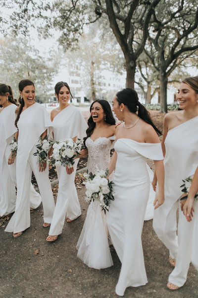 Elyse Jennings Weddings bride and bridesmaids in white jumpsuits