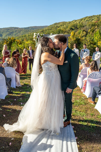 Groom kisses his bride after getting married.
