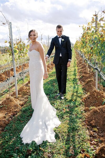 Groom seeing back of bride's dress for first time at Early Mountain Vineyard Wedding.