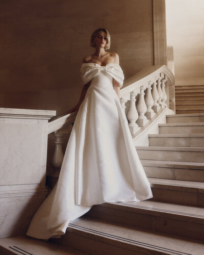 black and white image bride wearing strapless satin wedding dress with long train