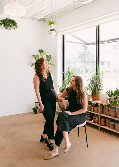 Organic growing floral installation, ceremony floating arch, floral hues of peach, pink, purple, and natural greenery. Design by Rosemary and Finch in downtown Nashville, TN.