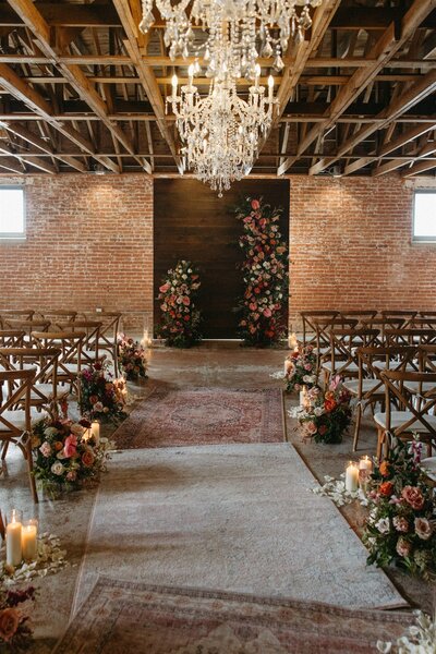 Spring wedding ceremony space decorated with colorful florals at the St Vrain, Longmont wedding venue.