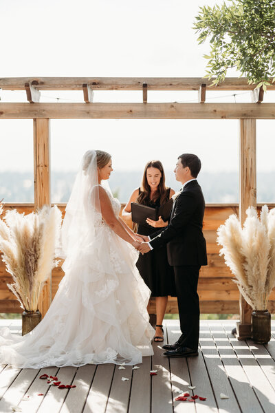Colorado Elopement Photographer captures bride and groom holding hands at alter