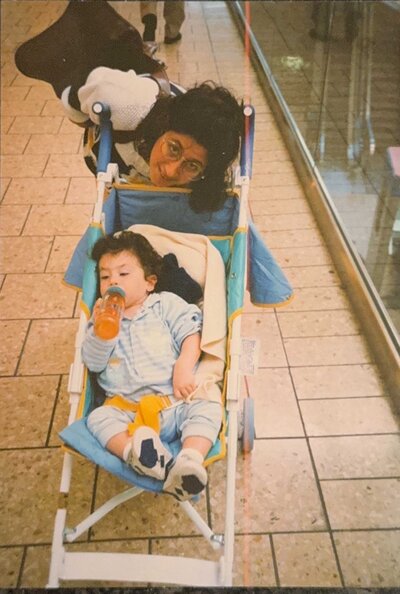 A mom pushing a child in a stroller