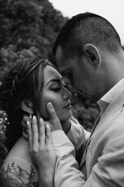 Romantic photo of couple on their wedding day, nose to nose. Photo is in black and white