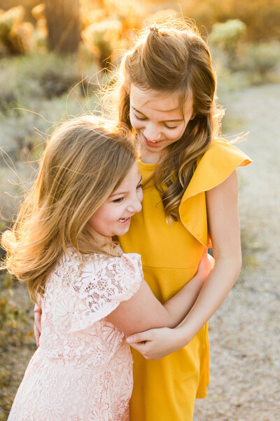 sister hugging each other for Scottsdale family photography photos