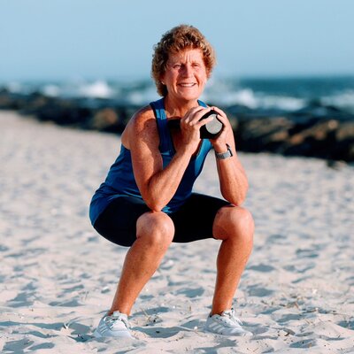 Helen Ann lifting a dumb bell in her at-home gym