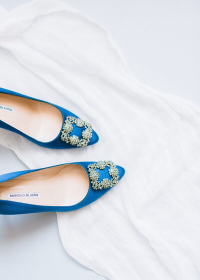 Elegant blue Manolo Blahnik wedding shoes, a timeless detail for a luxury Charleston wedding. Captured by Amia Marcell, one of the best wedding photographers in Charleston, specializing in elegant and classic wedding photography.