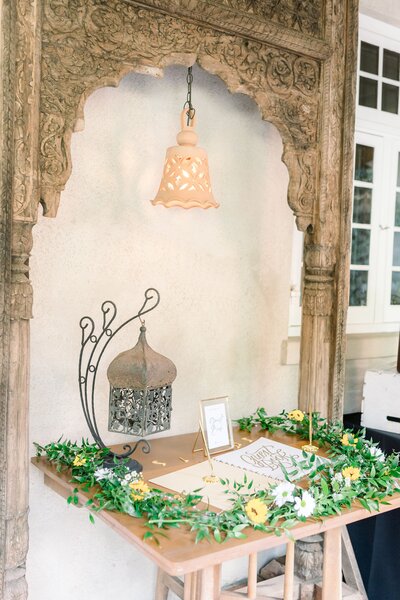 Ornate arch and table with wedding information