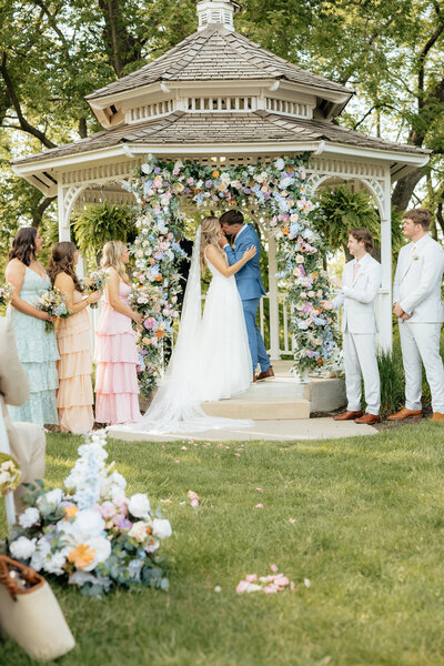 A bride and groom kissing.