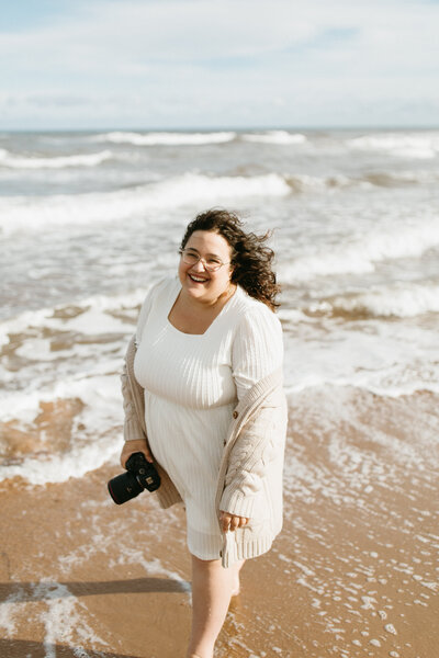 A solo portrait of Ottawa wedding photographer, Valerie Doucette, on the beach.