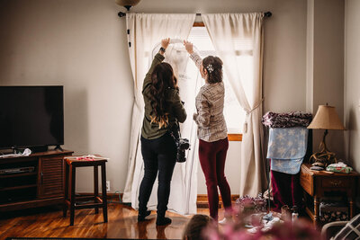 Akron alt photographer helps bride get ready for wedding day.