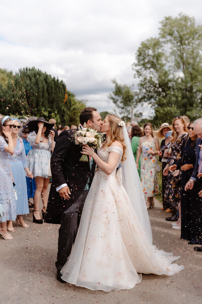 Kirsty and Jack Wedding Ceremony confetti kiss. Bride wearing Josephine Scott  Constance dress