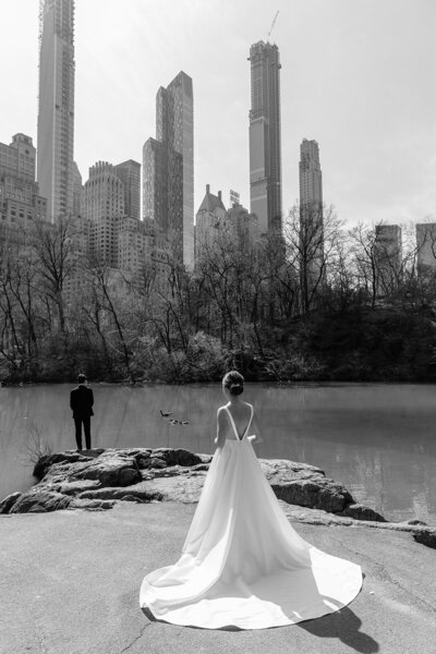 black and white photograph of a bride walking to her husband in central park NYC
