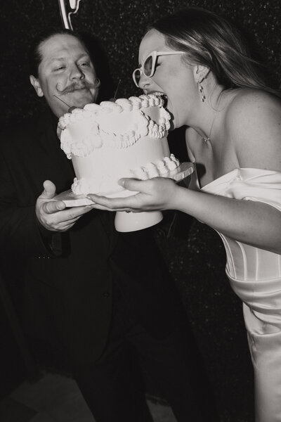 Groom feeds the bride a wedding cake