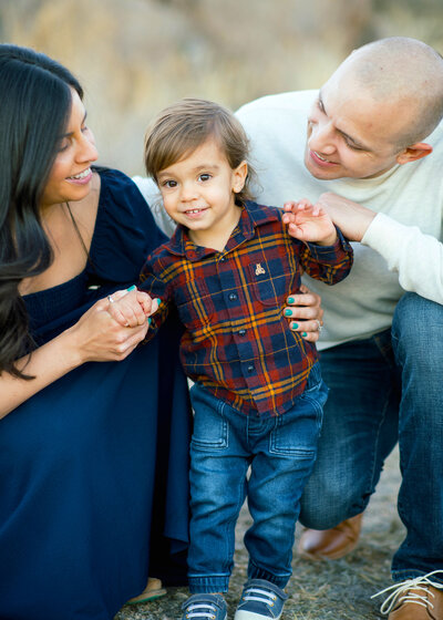 mother and father with toddler posing for family photos in carfree az