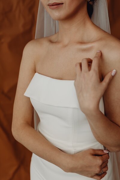 a bride wearing a white wedding dress