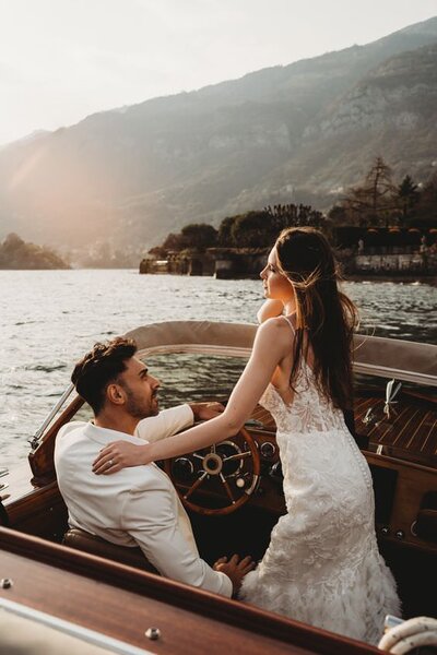 bride and groom on speed boat in lake como