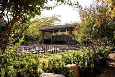 San Francisco Bay Area wedding photographer captures outdoor ceremony setup with vineyard views and natural landscaping at Estate Yountville in Napa Valley