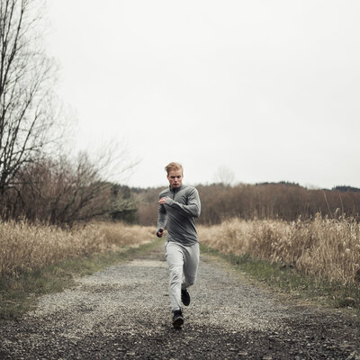 young man running on a dirt path