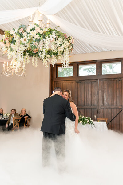 Couple shares a romantic first dance at Cypress Creek Farmhouse Orlando wedding venue.