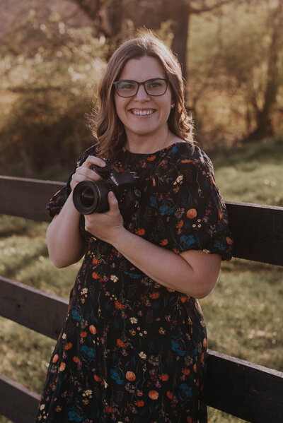 photographer Danielle Towle holding camera outside