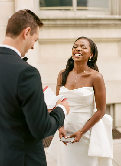 Happy bride in strapless gown black wedding planner