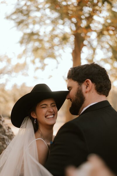 bride and groom pose for photos at wedding venue in peoria illinois