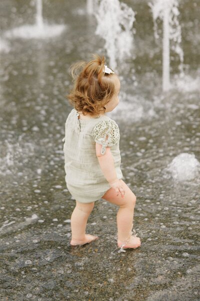 Toddler girl playing in splash pad at Moncus Park
