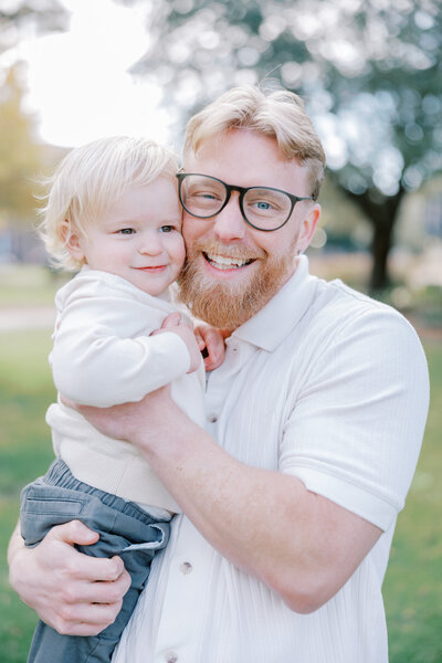 Shelby's husband Kin holding their baby Oliver
