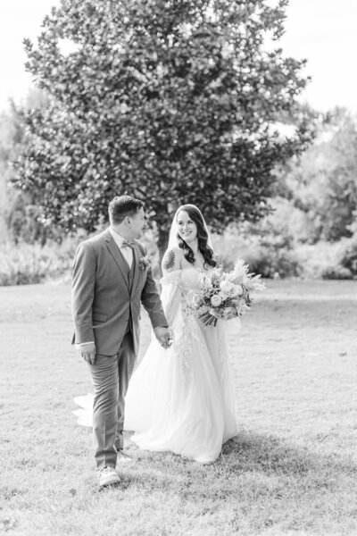 bride and groom walking in a park taken by st. louis mo wedding photographer