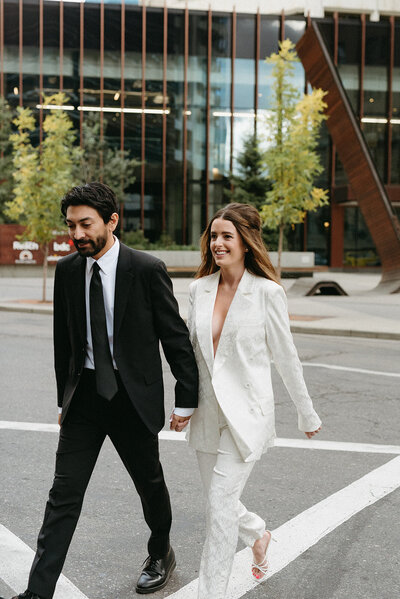 Wedding couple walking across Stephen Avenue in Downtown Calgary