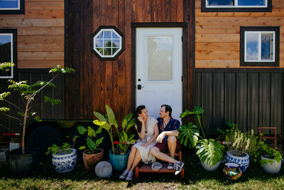 Couple sitting in front of their Tiny House for Couples Portraits