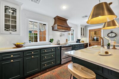 Beautiful kitchen with bronze accents and stainless steel appliances in this three-bedroom, two-bathroom vacation rental home featured on Chip and Joanna Gaines' Fixer Upper located in downtown Waco, TX.