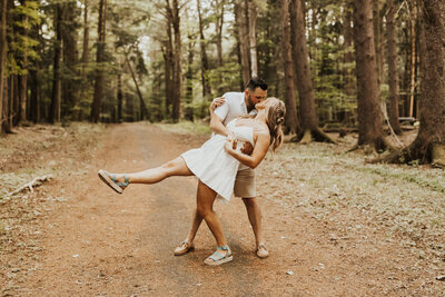 man dancing with woman in woods