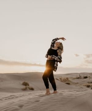 Portraits at Little Sahara Sand Dunes. Girl standing on sand dunes in creative pose with a sunflare