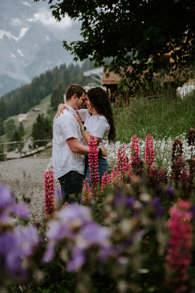 Couple between lupin flowers in Grindelwald, Switzerland