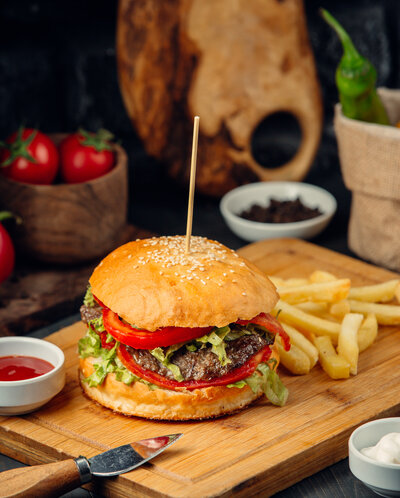 burger-bread-bun-with-potatoes-wooden-board